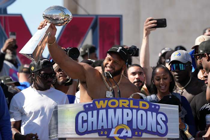 Feb 16, 2022; Los Angeles, CA, USA; Los Angeles Rams defensive end Aaron Donald holds the Vince Lombardi trophy during the Super Bowl LVI championship rally at the Los Angeles Memorial Coliseum. Mandatory Credit: Kirby Lee-USA TODAY Sports